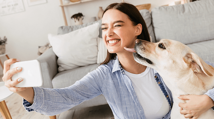 Woman taking selfie with dog